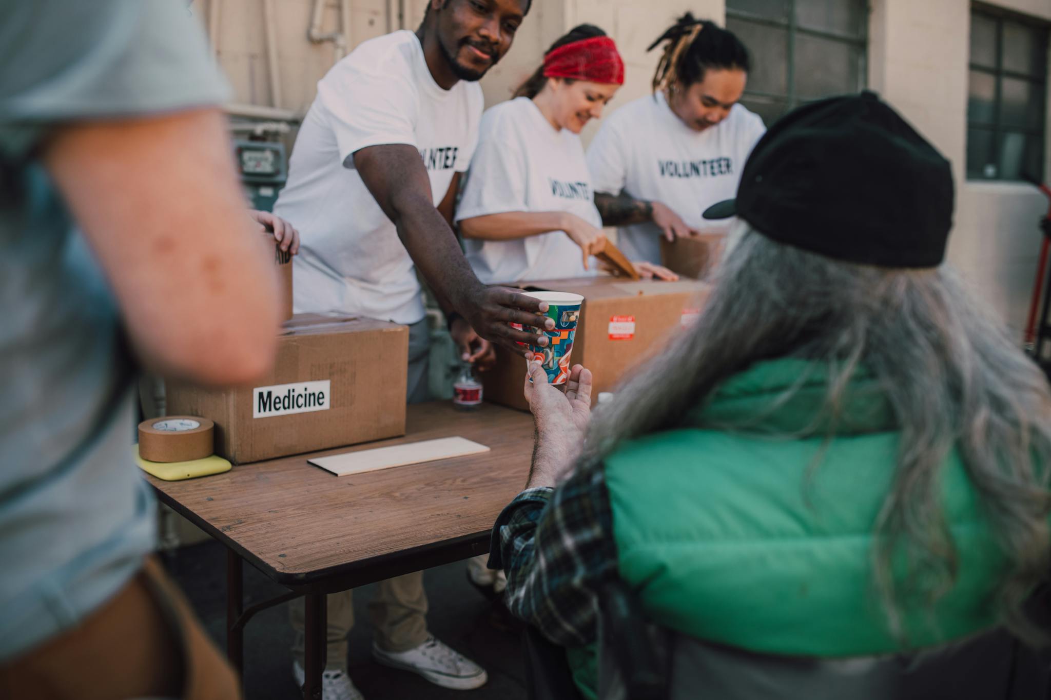 Volunteers handing out donations and support to those in need at a community event.